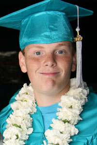 Boy in cap and gown at graduation