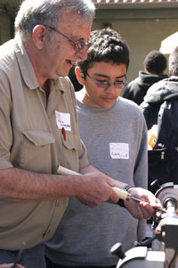 Older man showing a boy how to use a lathe