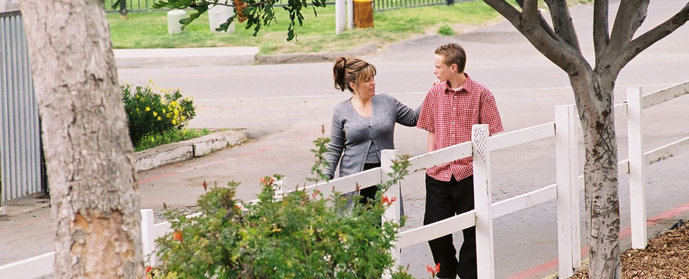 A mom walking with her son.