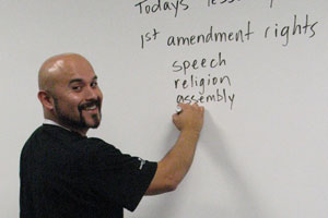 Teacher writing on whiteboard